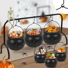 halloween decorations in black pots on a table