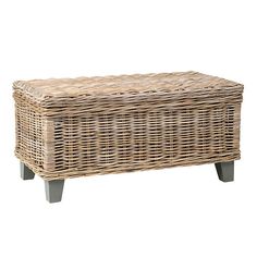 a wicker bench with legs and a cushion on top