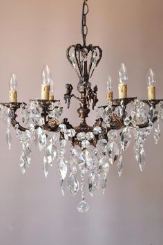 an antique chandelier with crystal drops hanging from it