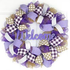 a purple and white wreath with the word welcome on it