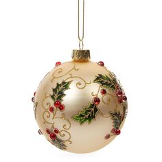 a glass ornament with holly and berries