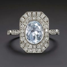 an oval cut blue topazte and diamond ring with pave diamonds surrounding it