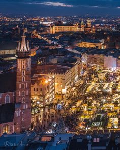 an aerial view of a city at night with lots of lights and buildings in the background