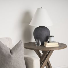 a table with a lamp on it next to a couch