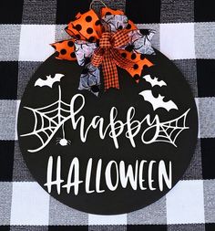 a black and white checkered table cloth with a happy halloween sign on it