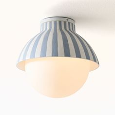 a blue and white striped light hanging from the ceiling