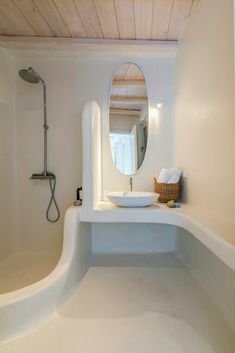 a bathroom with a sink, mirror and bathtub in the middle of it's walls