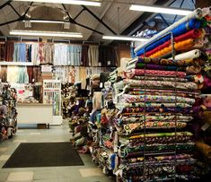 a store filled with lots of different colored fabrics