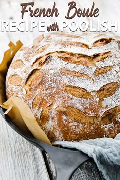 a loaf of bread with powdered sugar on top and the words french boule recipe with poolish