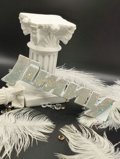 a white toothbrush sitting on top of a feathery tablecloth next to a statue