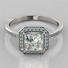 an engagement ring with a princess cut diamond in the center and pave set shoulders