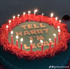 a birthday cake with lit candles on it that says tell harry i'm legal