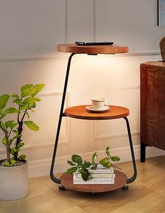 a table with a lamp on it next to a potted plant