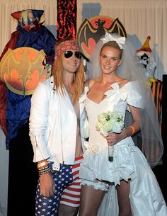 two people dressed up in costumes posing for a photo with one person wearing an american flag costume