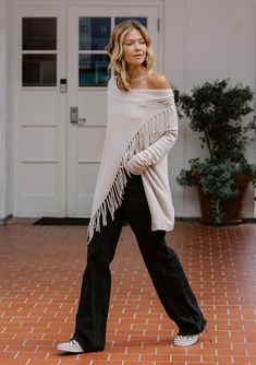 Our best-selling, classic fringed sweater in a super soft, pointelle knit. With inner and outer buttons, this bohemian lightweight sweater can be worn closed or open like a cardigan. FINAL SALE Pointelle knit Easy, relaxed fit Long sleeves Hip length Cowl neckline Inner & outer buttons to secure draped silhouette Can be worn as an open cardigan or buttoned up Model is 5'9, wearing a size S.Style: IMP-5797PIQ-NW Bohemian Soft Knit Long Sleeve Tops, Winter Tops With Frayed Hem And Relaxed Fit, Winter Top With Relaxed Fit And Frayed Hem, Bohemian Long Sleeve Soft Knit Tops, Winter Top With Frayed Hem And Relaxed Fit, Bohemian Fringe Sweater For Spring, Bohemian Spring Sweater With Fringe, Oversized Fringe Sweater For Fall, Oversized Fringe Sweater For Winter