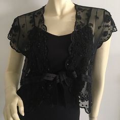 Dana Buchanan Black Short Sleeved Shrug Fully Embellished With Beaded Flowers And Trim. Size Large. New With Tags. Picture With Envelope In The Back Shows One Sequin Missing. Beautiful Shrug To Dress Up Slip Dresses Or Camis. Please Do Not Use My Photos Without Permission Black Shrug For Dresses, Elegant Beaded Festive Outerwear, Black Embellished Fitted Outerwear, Black Embellished Evening Outerwear, Elegant Embellished Black Outerwear, Elegant Fitted Sequin Outerwear, Elegant Black Embellished Outerwear, Elegant Black Party Outerwear, Embellished Fitted Evening Outerwear