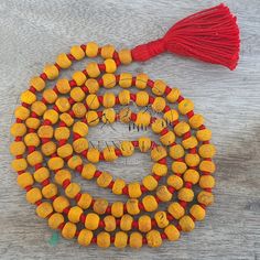 📿This Mala is handcrafted with Turmeric Beads. Turmeric is much revered by Hindus and is considered one of the most purifying herbs in Ayurveda. Each Bead is mindfully knotted with love, one at a time on a durable nylon silk chord for extra strength, to extend their lives & is finished with a Silk Tassel adorned with silver Zari. Historically, the tassel has worked as a talisman and is used as a sign of power, prestige, protection, and spiritual significance . One who wears / keeps Turmeric mala also acquires a good amount of spiritual powers.📿 📕 MATERIALS 📕 🦉Turmeric Beads 🦉Nylon Silk Cord 🦉Silk Tassels 🦉Silver Zari 📕 PRODUCT DIMENSIONS 📕 📏Mala Necklace Length: 41-43 inches approx 📏Tassel Length: 3.5 - 4.0 inches approx 📏Shape : Round 📏Size : 8 MM 📏Number Of Beads: 108 Mala Artisan Beads For Rituals And Festivals, Orange Beaded Necklaces With Wooden Beads As Gift, Orange Beaded Necklaces With Wooden Beads For Gifts, Artisan Orange Beaded Necklaces For Festivals, Orange Necklace For Festivals, Bohemian Beaded Necklace With 108 Beads For Puja, Spiritual Wooden Beaded Necklaces For Festivals, Handmade Orange Jewelry For Puja, Traditional Orange Beads For Gifts