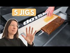 a woman standing in front of a machine with the words 5 jigs on it