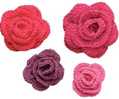 four crocheted flowers are shown in different colors