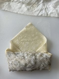 a piece of cheese sitting on top of a white counter