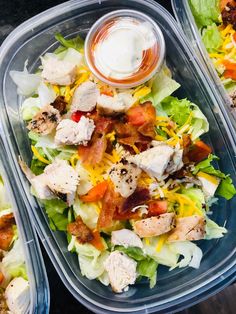 two plastic containers filled with salad and dressing