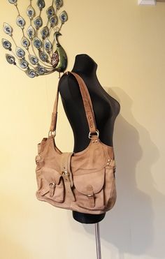 "Vintage Shoulder Leather Bag. Cappuccino brown handbag. British purse for women. Large tote bag. Brown textile lining. 2 frontal pockets with the magnetic closures. 1 zippered compartment inside. 1 slim, slip on open pocket inside. condition: great vintage. Without damages. measurements: width 38 cm / 15\" inches height without handles 26 cm / 10.1\" inches length of handles 70 cm / 27.3\" inches" Light Brown Bohemian Tote Bag, Bohemian Light Brown Tote Shoulder Bag, Bohemian Light Brown Bags For Everyday Use, Bohemian Light Brown Bag For Everyday Use, Vintage Beige Hobo Bag, Travel Hobo Bag In Soft Light Brown Leather, Light Brown Soft Leather Hobo Bag For Travel, Brown Hobo Bag With Pockets, Brown Canvas Satchel With Pockets