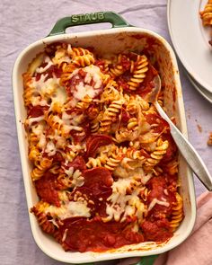 a casserole dish filled with pasta and sauce