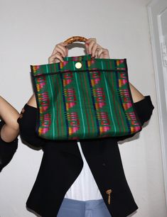 A unique roomy tote bag perfect for everyday use, the Nena bag is entirely made by hand in Spain. It is crafted in Cambaya fabric, a traditional Mexican cotton fabric made on wooden pedal looms, in Michoacán. This fun colorful bag is finished with a bamboo handle, and the interior is lined in black cotton fabric. Material: Cotton Cambaya fabric, bamboo handle HANDMADE IN SANTANDER, SPAIN Size: 16 x 15 x 5 in / 40,5 x 38 x 13 cms The Nena bag comes in a Cuckoo B cotton dust bag. Cuckoo B believes Santander Spain, Black Cotton Fabric, Colorful Bags, Traditional Mexican, Bag Green, Bamboo Handles, Mexican Style, Green Bag, Black Cotton