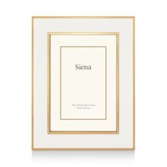 a white and gold framed photograph with the word sienna in black ink on it's side