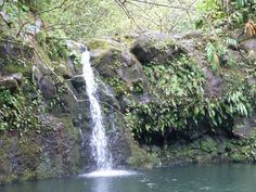 a waterfall in the middle of some water