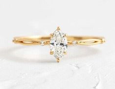 a yellow gold engagement ring with an oval cut diamond