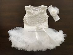 This beautiful French White Baptism Onesie and Tutu Dress is absolutely adorable. For your baby's comfort, it is made using soft and exquisite florette lace in a stunning French White color. The onesie is made of high quality cotton and the attached French White or French Ivory tutu skirt has multi-layer of soft fabric for a delicate fluff. The headband is handmade with beautiful flowers, accentuated by a pearl and rhinestones. This Baby French White Tutu Dress and headband set is perfect for ba White Tutu Dress, White Tutu Skirt, Baby Birthday Dress, White Tutu, Lace Headband, Headband Set, Baptism Dress, Christening Dress, Ivory Flowers