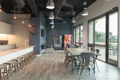 an empty restaurant with lots of tables and chairs