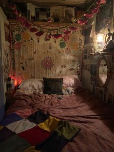 a room with a bed, mirror and pictures on the wall above it that is covered in fabric