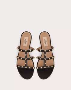 Rockstud Flat Slide Sandal for Woman Designer Calf Leather Sandals With Studded Outsoles, Designer Studded Flat Sandals, Leather Sandals With Gold Studs And Round Toe, Designer Flat Sandals With Studded Rubber Outsoles, Designer Flat Sandals With Studded Outsoles, Rockstud Flats, Valentino Sneakers, Valentino Sandals, Woman In Black