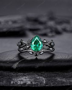 Rhodium black engagement ring like no other. This AMAZING piece of fine jewelry is the perfect expression of your eternal love. Its BLACK colors bring out the beauty of this ring. Black gold finish pear cut emerald engagement ring set, rhodium black teardrop emerald bridal set, gothic anniversary ring, witchy black plating emerald promise ring gift for women, mom, best friend, girlfriend and wife. ★Description Main ring: *Center stone: 1.0 carat 6x8mm Pear Cut Lab Created Emerald * Material: sil Emerald And Black Ring, Black Gemstone Wedding Rings, Black Emerald Jewelry For Gift, Black Emerald Ring For Formal Occasions, Black Solitaire Ring As Gift, Black Wedding Ring With Emerald, Black Sapphire Ring With Accent Stones For Wedding, Black Diamond Promise Ring Fine Jewelry, Black Diamond Promise Ring In Fine Jewelry Style