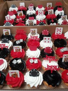 cupcakes decorated with red, white and black icing are displayed in boxes