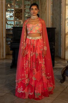 Cherry red georgette lehenga with naksha and floral prints. Comes with print, embroidered highlighted padded blouse and net embroidered dupatta.
Components: 3
Pattern: Printed, Embroidered
Type Of Work: Naksha, Floral Patterns, Mirror Work
Neckline: Sweetheart
Sleeve Type: Sleeveless
Fabric: Lehenga : Georgette, Blouse : Cotton silk, Dupatta : Net
Color: Red
Other Details: 
Lehenga:
Attached lining
Mirror work on waistbelt
Embroidered highlights
Closure: Side zip
Blouse:
Padded
Attached lining
C Paulmi And Harsh, Blouse Yoke, Printed Lehenga, 1950’s Fashion, Georgette Lehenga, Organza Lehenga, Navy Blue Print, Lehenga Skirt, Red Lehenga