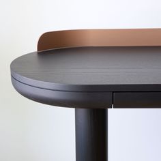 a close up of a black table with a brown top