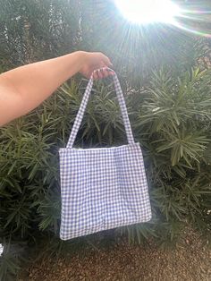 Make a statement with this quilted blue and white gingham tote bag. Inside has 2 pockets Casual Gingham Shoulder Bag For Picnic, Casual Gingham Shoulder Bag For Summer, Picnic Tote Bag With Handles, Gingham Tote Bag For School, Rectangular Plaid Shoulder Bag For Picnic, Rectangular Gingham Bags For Summer, Preppy Gingham Rectangular Bag, Gingham Bags For Daily Use In Spring, Spring Gingham Bag For Daily Use