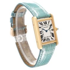 Cartier Tank Louis Yellow Gold Teal Leather Strap Mens Watch W1529756. Quartz movement. 18k yellow gold case 25.0 x 33.0 mm. Circular grained crown set with a blue sapphire cabochon. . Scratch-resistant mineral crystal. Silvered opaline dial with black radial Roman numeral hour markers and inner minute track. Sword shaped blue hands. Date calendar at 3 o'clock aperture. Secret Cartier signature at VII. Teal leather strap with 18K yellow gold tang buckle. Cartier Tank Louis, Sapphire Cabochon, Teal Leather, Amazing Watches, Used Watches, Cartier Tank, Date Calendar, Cartier Watch, Roman Numeral