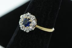 "Antique (ca. 1920), 14K Yellow Gold and Platinum Top, Natural Sapphire and European Cut Diamond Ring, Size 4 1/2 The sapphire is 4.5mm in diameter and weighs .45ct+/-. There are eight European cut diamonds (8-EC-.40+/-ct tcw; G/H,SI1+). The top of the ring is 8.90mm wide and the bottom of the shank is 1.41mm wide. This ring is a size 4 1/2 and it weighs 2.2 grams. Most items purchased before 2pm EST will be shipped same day using USPS First Class Mail (\"2-3day\") and will be insured, requiring 14k Gold Heirloom Cluster Ring, Heirloom 14k Gold Cluster Ring, Art Deco 14k Gold Cluster Ring Hallmarked, Art Deco Hallmarked 14k Gold Cluster Ring, Hallmarked 14k Gold Art Deco Cluster Ring, Art Deco Hallmarked Yellow Gold Cluster Ring, Collectible 14k Gold Diamond Ring, Hallmarked 14k Gold Cluster Ring, Fine Jewelry 14k Stamped Round Cluster Ring