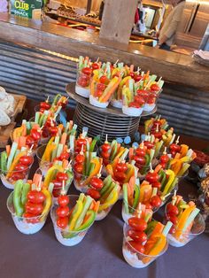 many small cups filled with different types of vegetables