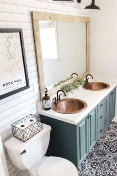 a bathroom with two sinks, a toilet and a mirror above the sink is decorated in black and white tiles