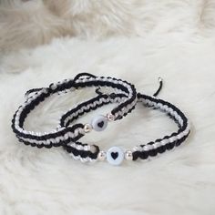 two black and white bracelets with silver beads