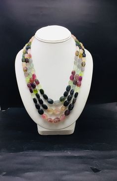 100% Natural Multi Tourmaline hand carved oval shape beaded necklace with adjustable silk cord closure.  Details: - Gemstone - multi-Tourmaline Shape - Oval  Strand - 3 Calibration - 9x11 millimeters till 12x16 millimeters Gross weight - 838.05 carat Net weight - 811.05 carat Length - 17 Inches (Inner) and 20 Inches (Outer) SKU - HJSPSAR0037 100% NATURAL TOURMALINE BEADS READY TO WEAR NECKLACE ADJUSTABLE SILK CORD CLOSURE  VERY NICE LOOKING NECKLACE MULTI-COLORS OF NATURAL TOURMALINE Thank you for your kind visit to my shop. NOTE: - You will receive the same product you see in the picture.   Dear Buyers, please feel free to ask questions    We will be glad to answer & solve query regarding this product RETURN POLICY: -   Every piece of jewelry and inputs ( gemstones, diamonds, making, and Indian Customs, Wear Necklaces, Tourmaline Beads, Silk Cord, Rough Gemstone, Tourmaline Gemstone, Natural Colors, Natural Red, Gemstone Necklace