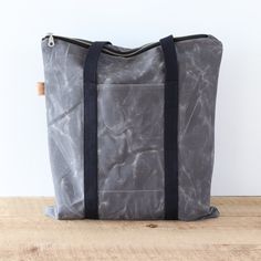 "This waxed canvas tote bag will hold a 13 inch laptop and a bunch more. Like all my bags, it is vegan. There's an exterior pocket that will fit your phone, and 3 interior slip pockets for all your essentials. The exterior is made of 13 oz waxed cotton canvas.  Waxed Canvas acts as a natural water repellent, so you'll love having it by your side rain or shine.  Waxed canvas has a worn and rustic appearance and texture.  It is normal for it to look like it has scratches and creases.  Bag Details ▪️Bag measures  15.5 (H) x 14 (W), lays flat ▪️Tote handles are 25 inches long ▪️Lined with black cotton twill fabric ▪️Interior triple slip pockets ▪️YKK top zipper closure ▪️Choose antique brass or silver hardware  ▪️Double stitched outer seams  ▪️Black cotton webbing tote handles  ▪️Easily fits a Outdoor Canvas Tote Bag With Zipper Closure, Functional Waxed Canvas Bag With Zipper, Functional Waxed Canvas Bags With Zipper, Practical Waxed Canvas Bag, Functional Everyday Waxed Canvas Bag, Practical Canvas Bag With Zipper For Outdoor, Practical Outdoor Canvas Bag With Zipper Pocket, Duck Canvas Bag With Zipper Pocket For Everyday Use, Functional Canvas Bag With Ykk Zipper