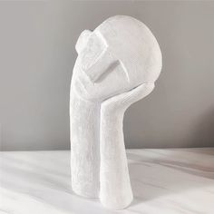 a white sculpture sitting on top of a table