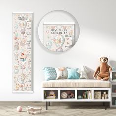 a teddy bear sitting on top of a bench next to a wall with a growth chart