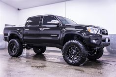 a large black truck parked in a garage